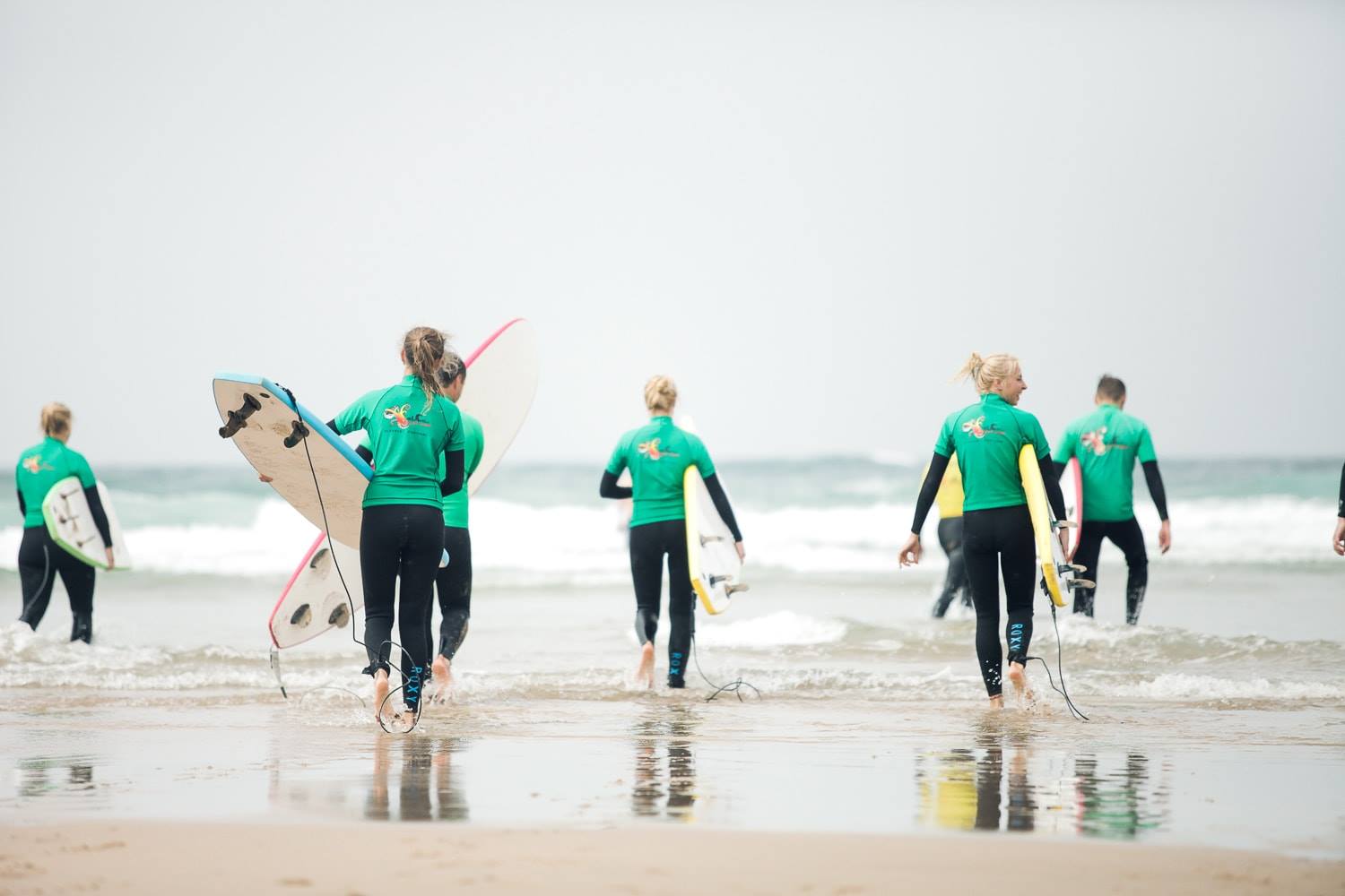 Surfers walking out to the sea in Algarve